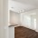 a room with a wood floor and a railing